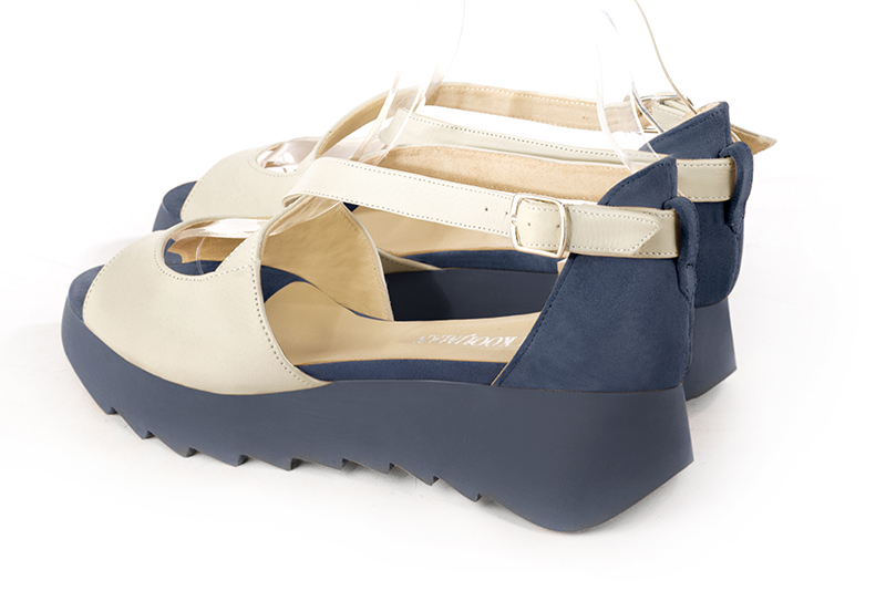 Off white and denim blue women's closed back sandals, with crossed straps. Round toe. Low rubber soles. Rear view - Florence KOOIJMAN